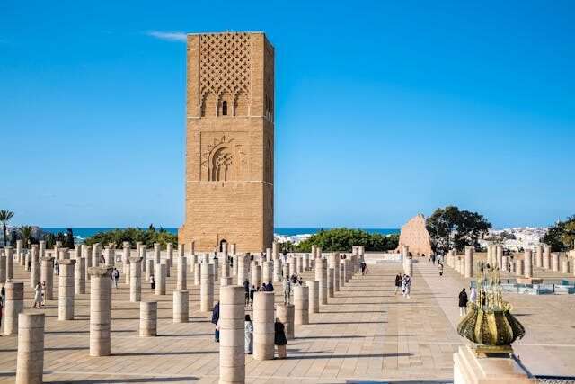 Explore rabat on a 10 days morocco tour, Hassan Tower in Rabat, Morocco – 12th-century red sandstone minaret with intricate carvings under a clear blue sky