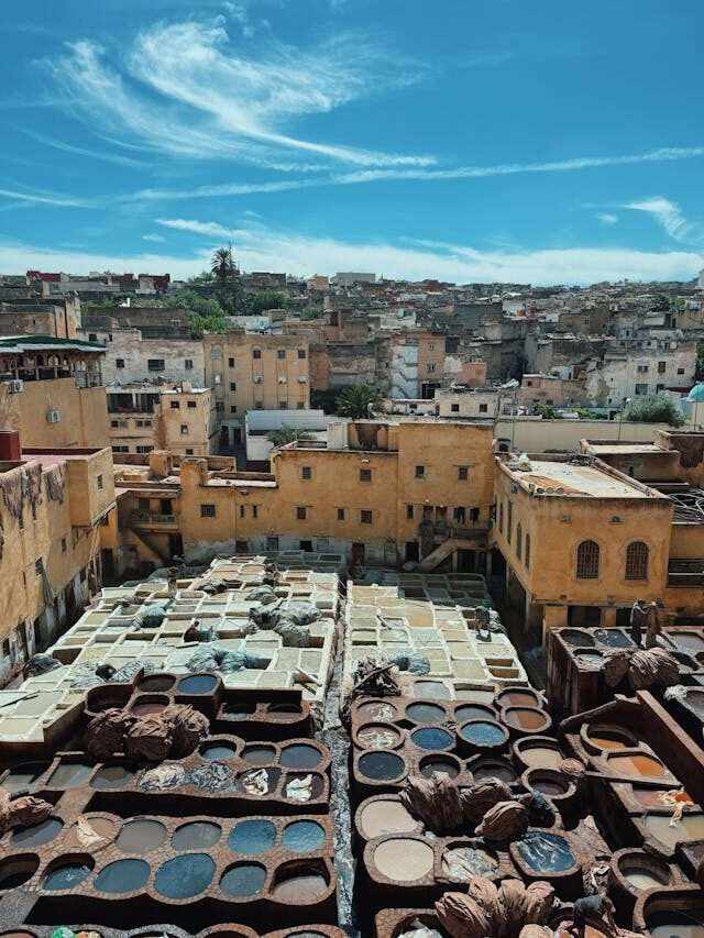 Panoramic view of Fes medina with traditional rooftops, minarets, and narrow winding streets in Morocco’s cultural capital